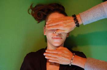 Reiki hands on a woman's head -ajanafitness.com